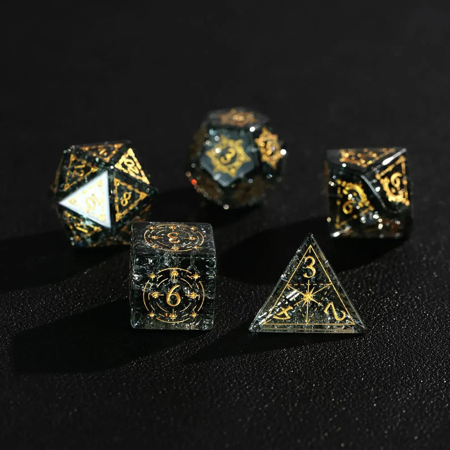 Several of the sharp-edged green glass dice are stacked on top of each other, showcasing their facets, luster, and overall design