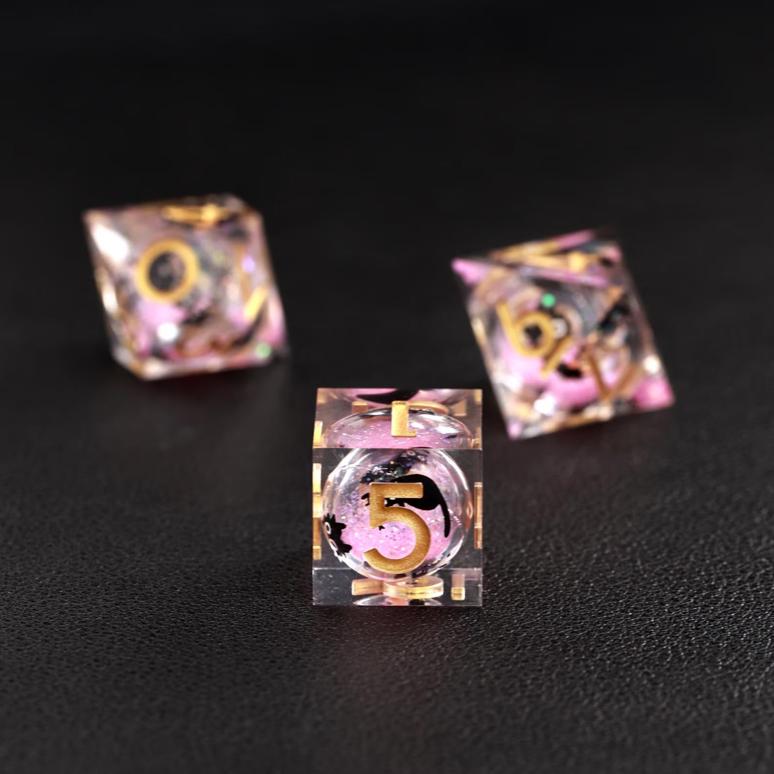 Tabletop RPG accessory: The Pink Swirl Liquid Core Dice Resin Set featuring the charming black cat animal dice.