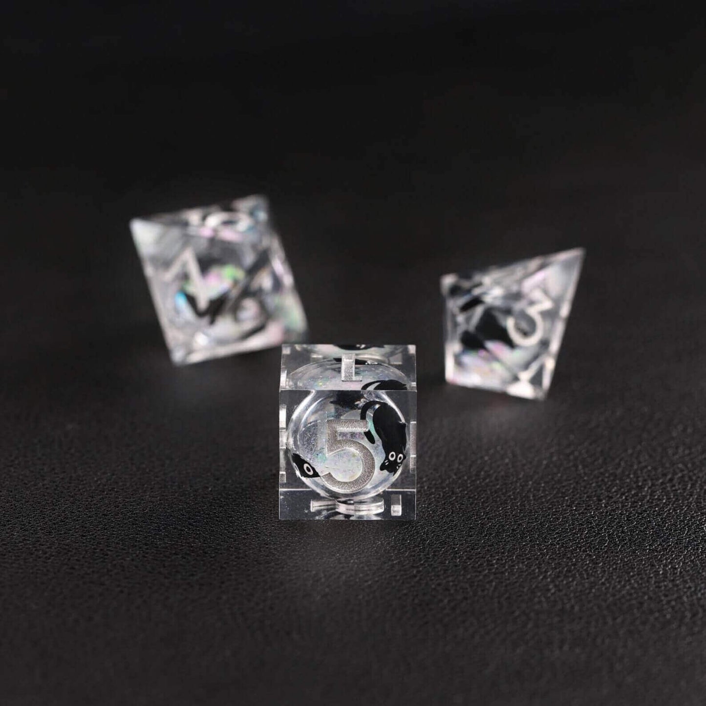 Tabletop RPG accessory: The Silver Swirl Liquid Core Dice Resin Set featuring the popular black cat animal dice.