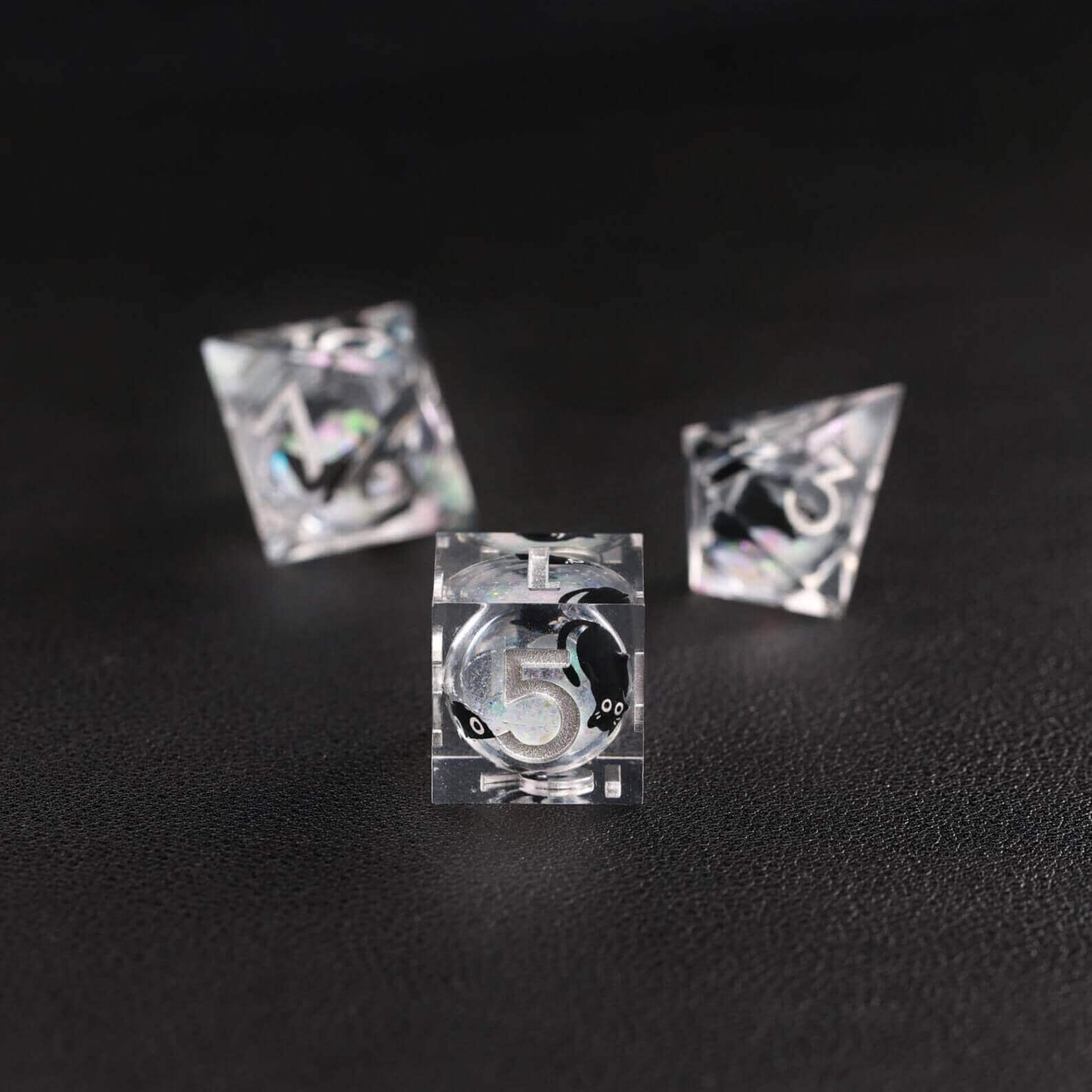 Tabletop RPG accessory: The Silver Swirl Liquid Core Dice Resin Set featuring the popular black cat animal dice.