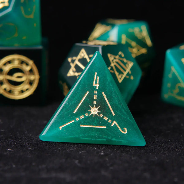 The pyramid-shaped D4 die with deep green cat's eye effect. The engraved number on the bottom face is clearly shown on a black background.