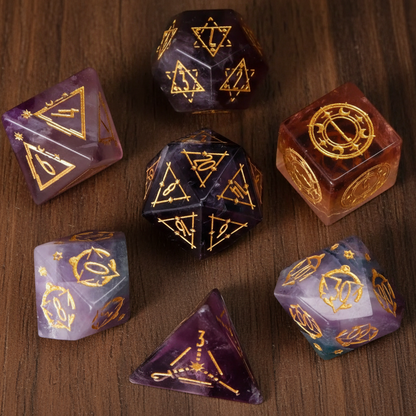 A complete set of seven purple fluorite gemstone dice for DND, intricately engraved and neatly arranged on a walnut wood table.