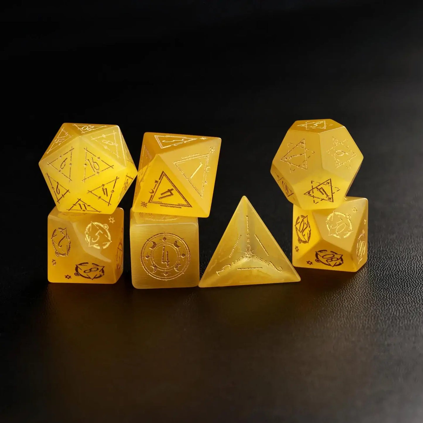 Six Handcrafted DND Yellow Cat's Eye Polyhedral Dice laid out, demonstrating the various shapes included in the set.