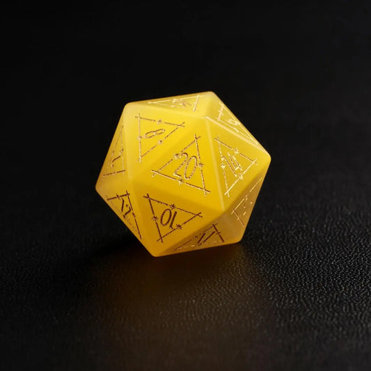 Close-up of a single Yellow Cat's Eye Gemstone Dice D20, a handcrafted DND polyhedral die on a dark black background, highlighting the distinct yellow cat's eye flash effect.