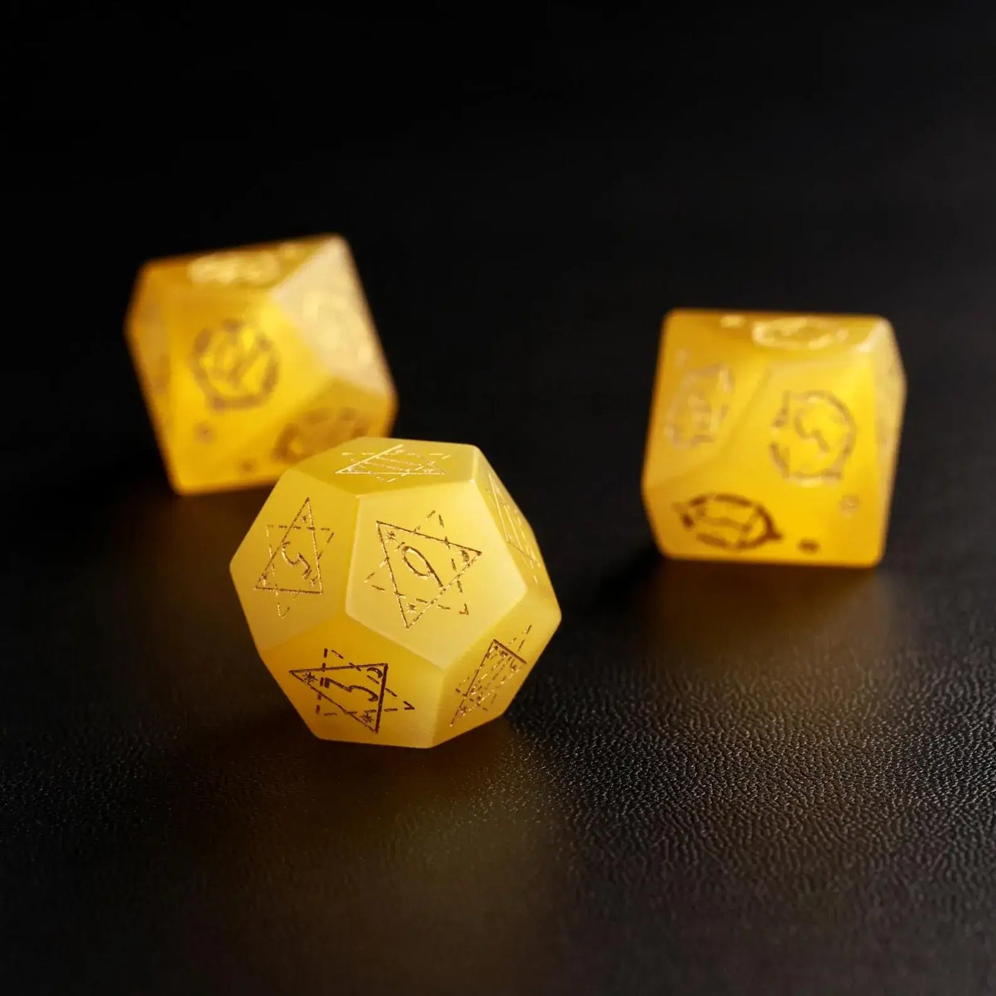 Group of three Yellow Cat's Eye Gemstone Dice (e.g., D8, D10, D%) arranged together, perfect for a DND Polyhedral Dice collection on a dark background