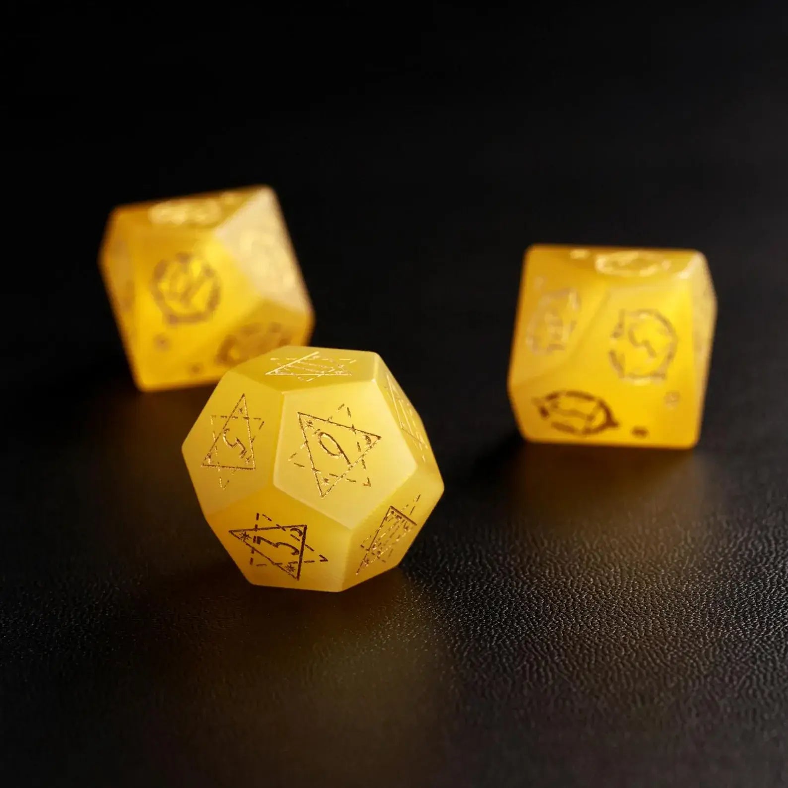 Group of three Yellow Cat's Eye Gemstone Dice (e.g., D8, D10, D%) arranged together, perfect for a DND Polyhedral Dice collection on a dark background