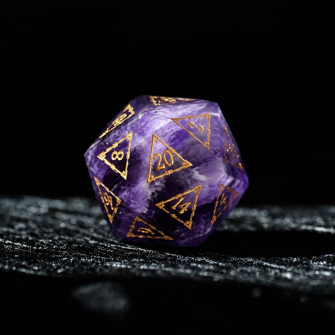 Natural Amethyst dice D20 with gold numbers on black fabric