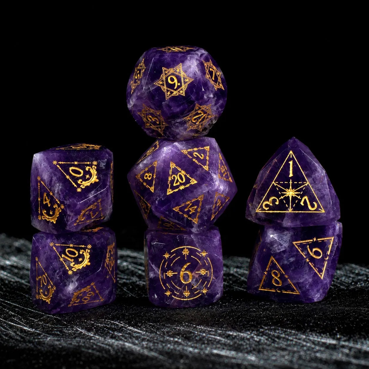 Natural Amethyst dice set stacked on black fabric with gold celestial numbers