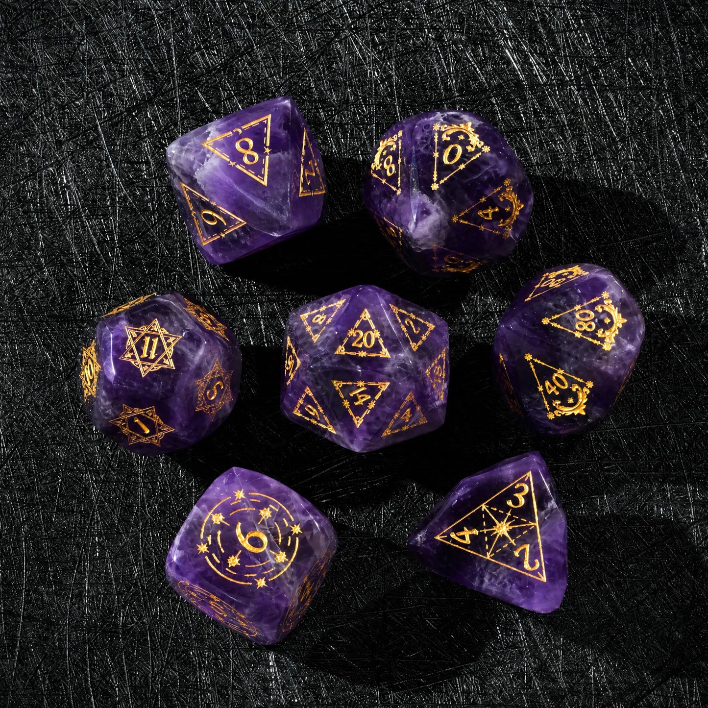 Top view of a Natural Amethyst dice set with gold engraved numbers