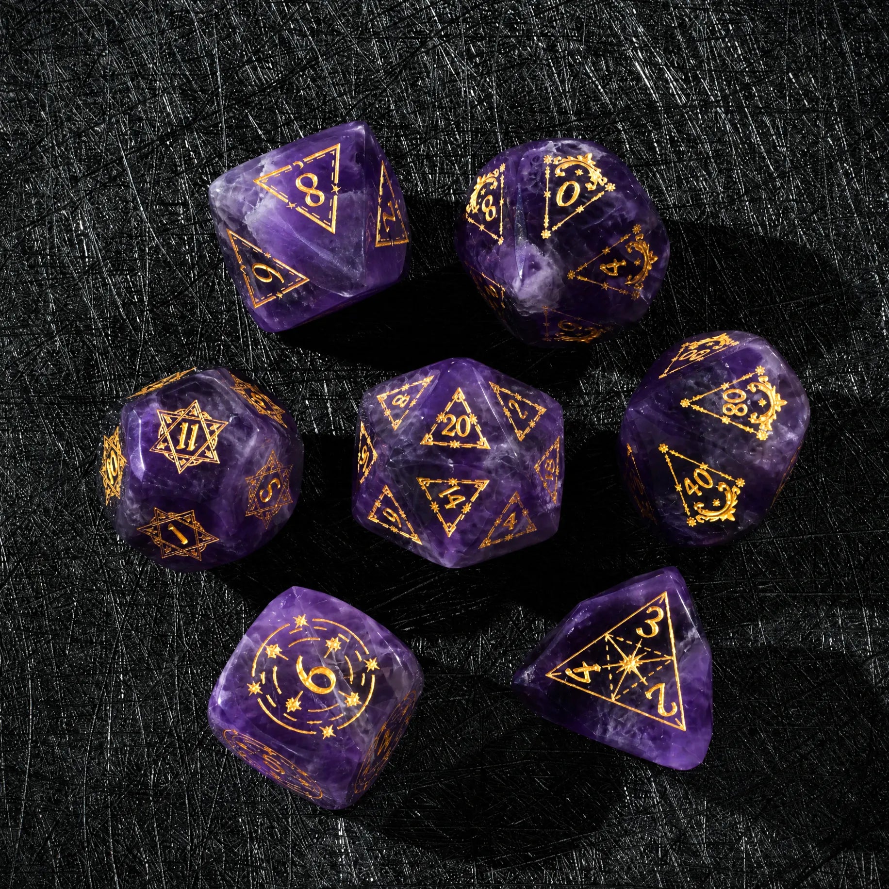 Top view of a Natural Amethyst dice set with gold engraved numbers