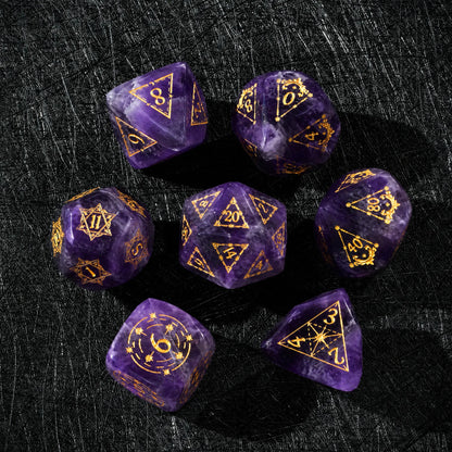 Top view of a Natural Amethyst dice set with gold engraved numbers