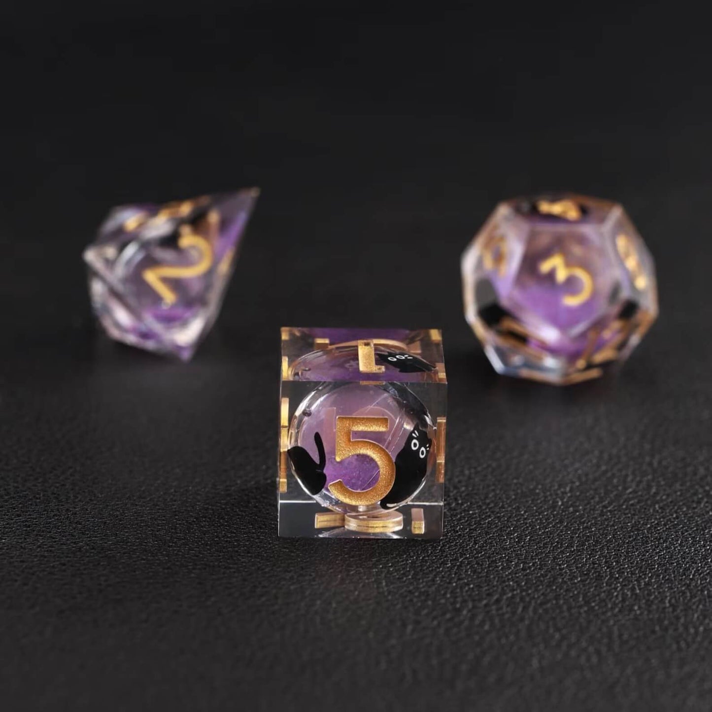 Purple swirl liquid core animal dice showing D6 and D8, handcrafted resin set with black cat core detail