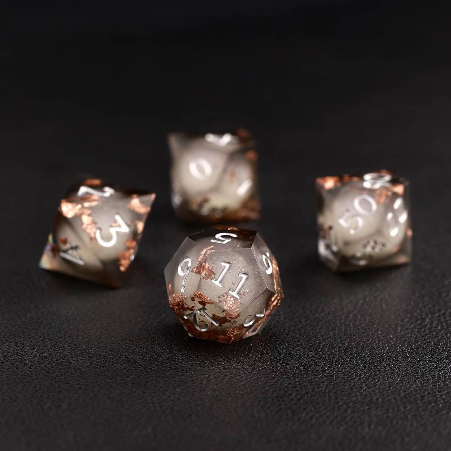 Black Copper Foil Liquid Core D12 resin dice with polished gemstone-like finish