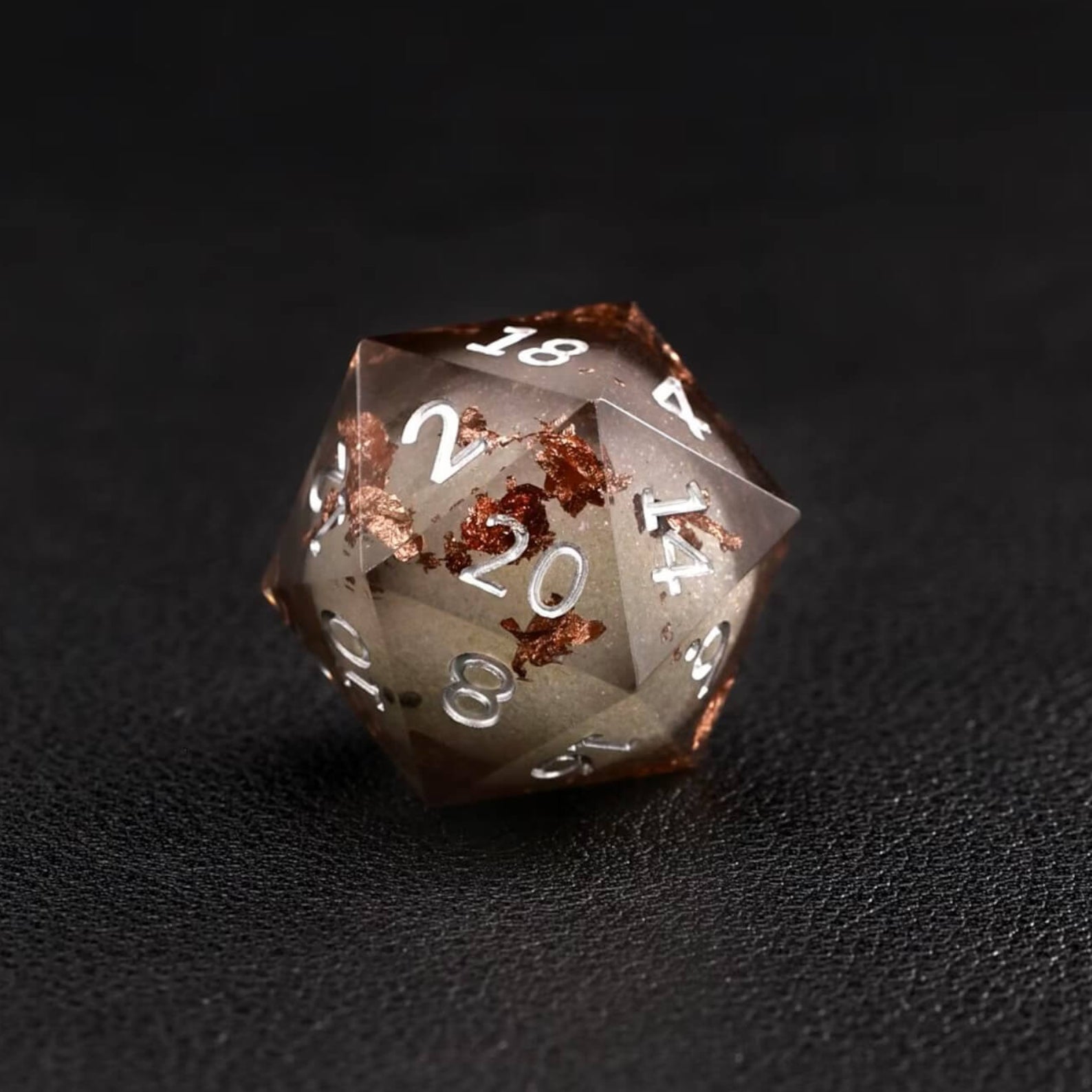 Black Copper Foil Liquid Core D20 Resin Dice displayed with RPG miniatures and character sheets