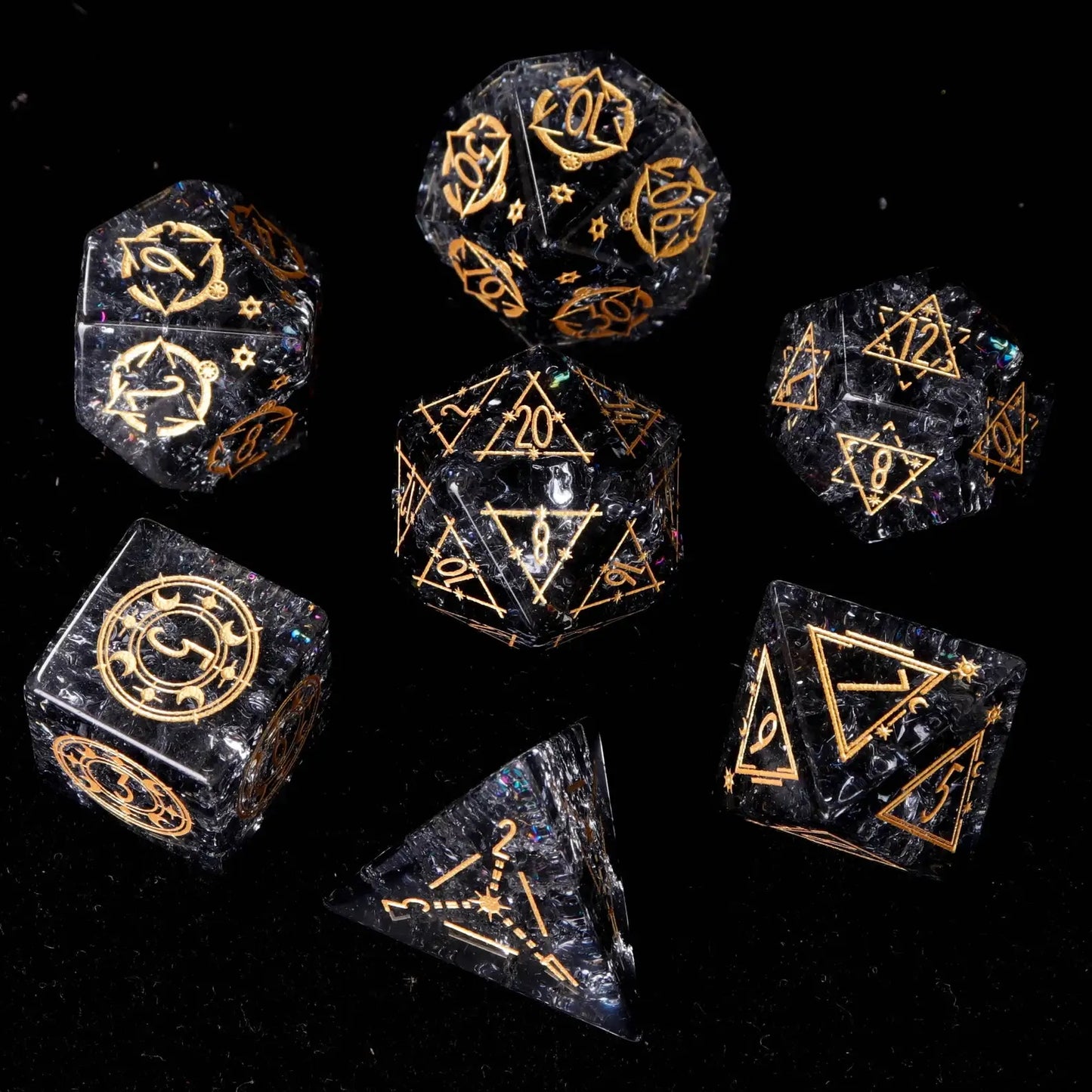 Full presentation of the Black Crystal DND Dice Set, showcasing all seven sharp-edged polyhedral dice with gold inlaid numbers, arranged formally on a luxurious dark slate surface.


