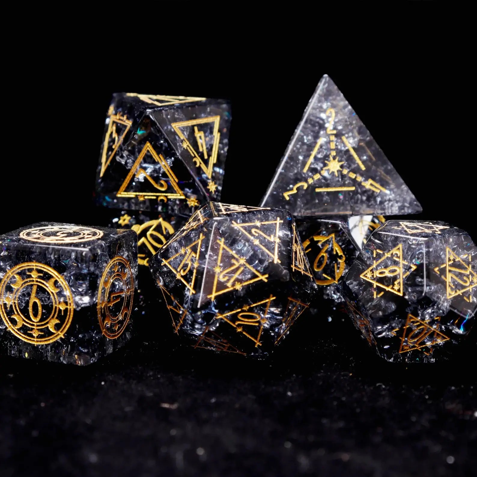 Overhead view of the full Black Crystal dice set arranged in order on a matte black surface