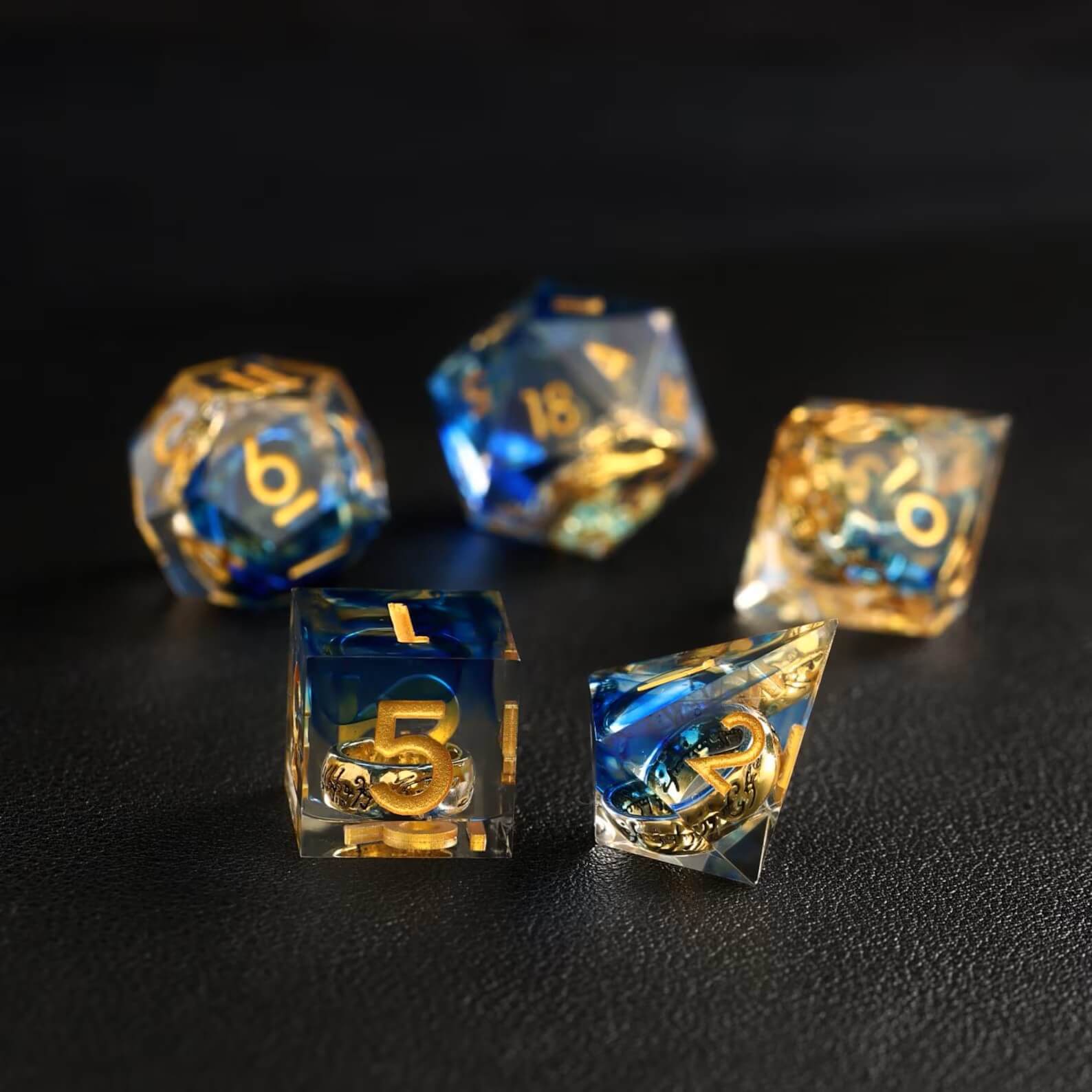 Close-up of Blue Brass Ring D4 resin dice with sharp edges for precise rolls