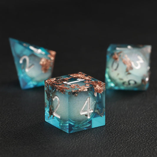 Close-up of Blue Copper Foil Liquid Core D4 resin dice with shimmering core and sharp edges