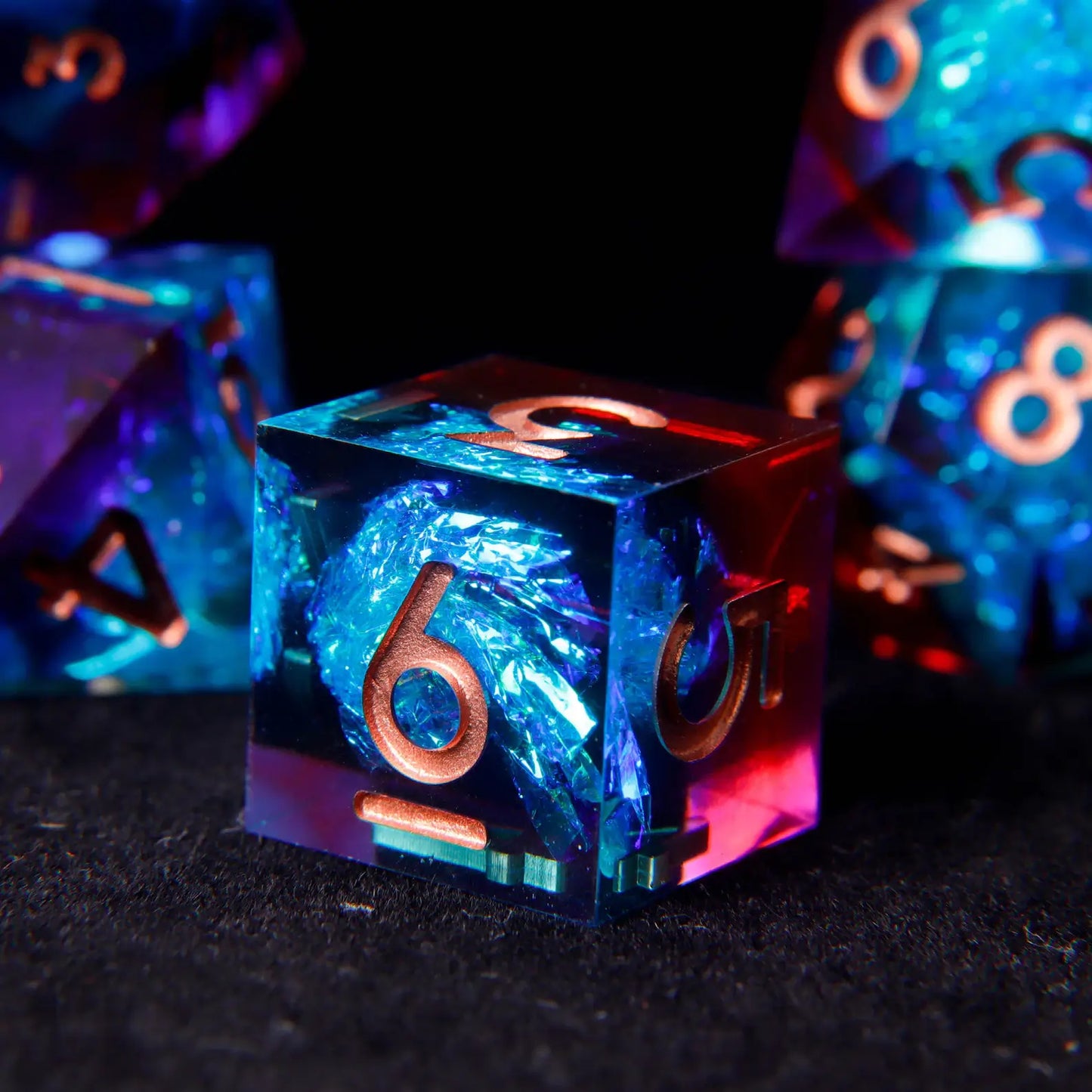 Classic cube D6 die with sharp blue-red laser iridescent edges and clear rose gold pips. A sleek, modern design for tabletop gaming.