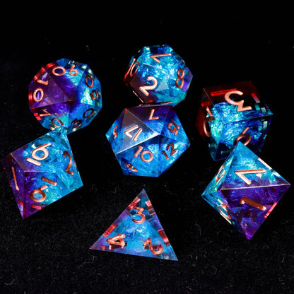 Full set of seven polyhedral dice with blue-red laser iridescent finish and elegant rose gold engraved numbers, neatly arranged to show all faces.