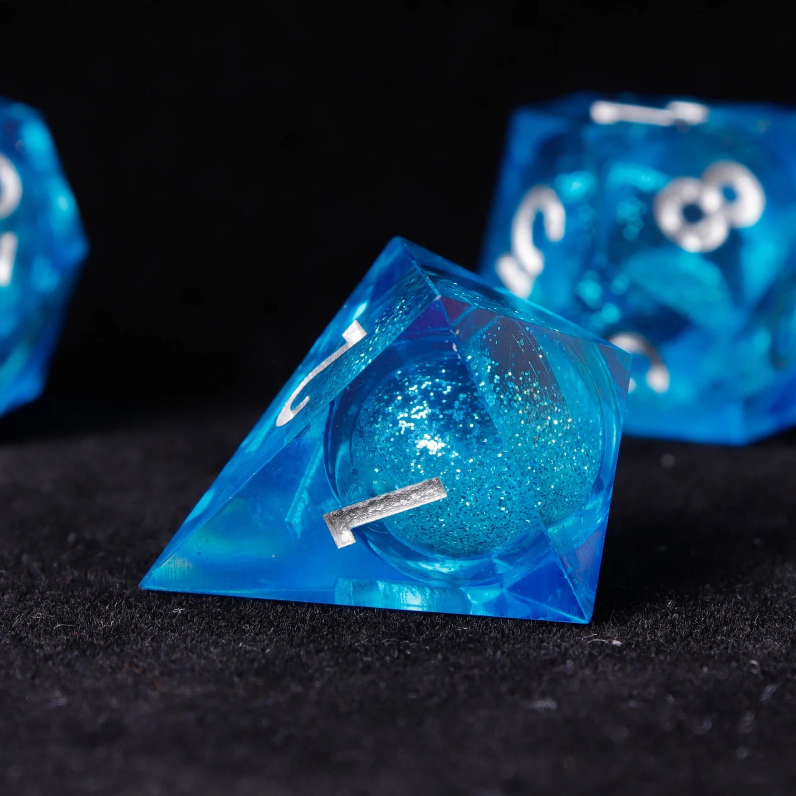 Hand holding complete Blue Starry Liquid Core Resin Dice Set for Dungeons & Dragons