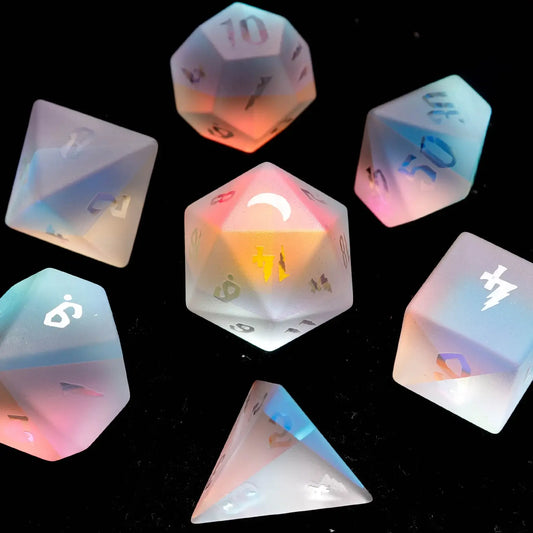 A full 7-piece set of D&D Dichroic Prism Glass dice with a matte frosted finish, showcasing soft, shifting rainbow color tones.