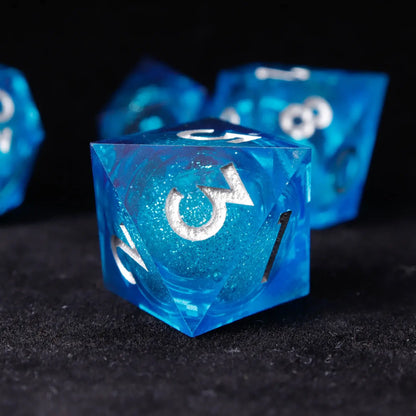 Macro shot of silver-engraved numbers on sharp-edge Blue Liquid Core Resin Dice