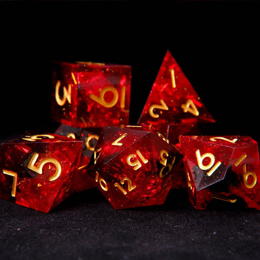 7-piece set of sharp edge DND dice in translucent fiery red solid resin with gold numbers.