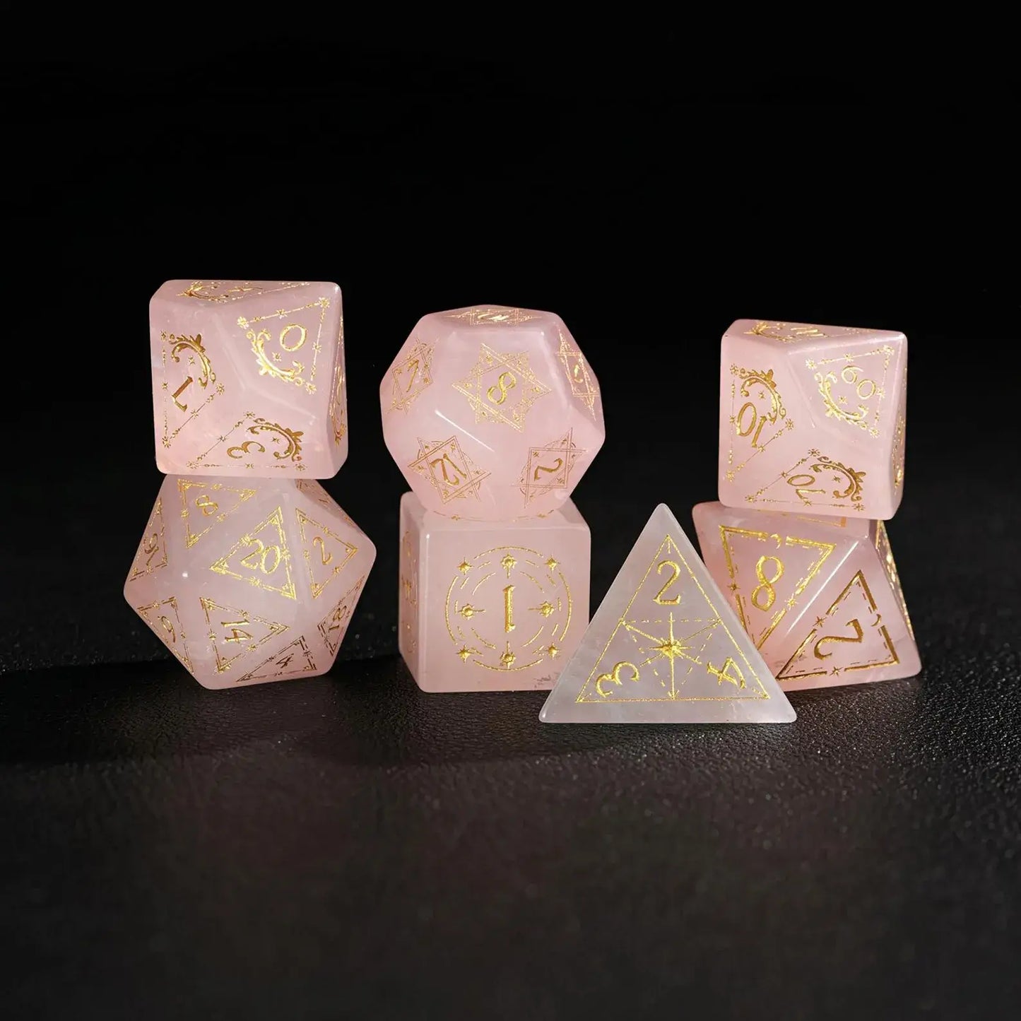 Complete 7-piece Pink Crystal Engraved Dice Set in standard flat lay arrangement on matte black surface.