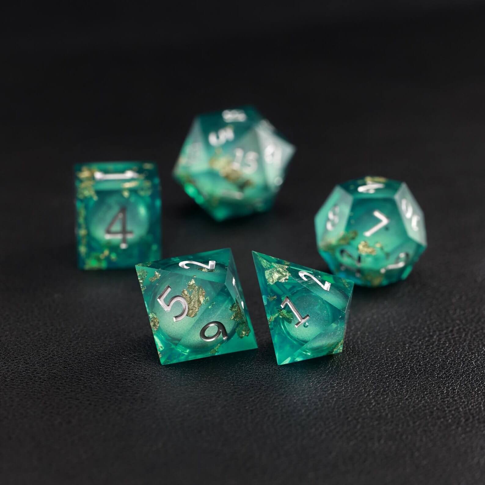 Close-up of Green Copper Foil Liquid Core D4 resin dice with shimmering core and sharp edges