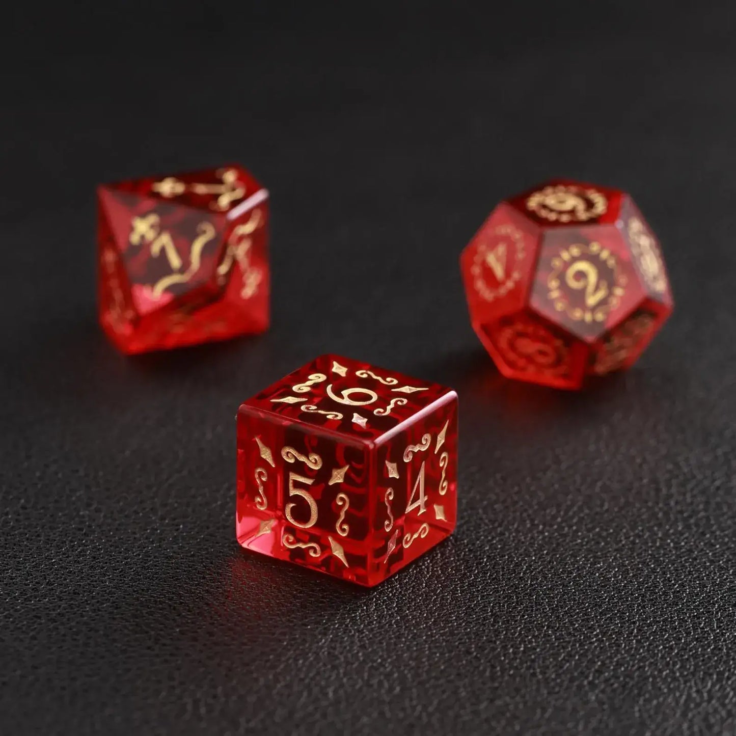 Macro shot of the handcrafted Garnet D6 against a black background, highlighting the quality of the engraving and weight.
