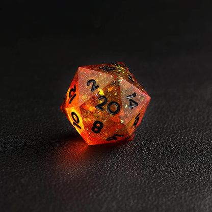 Top view of orange red D20 dice with sharp edges reflecting light
