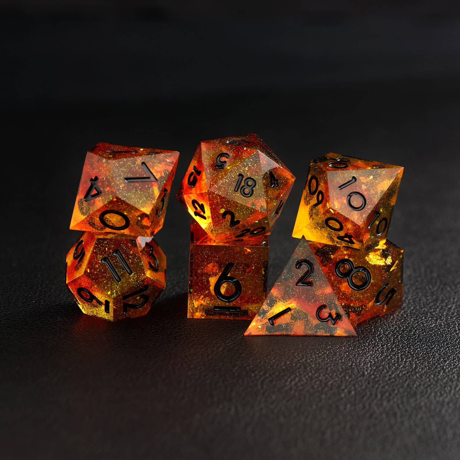 Group of orange red sharp-edge DND dice arranged neatly, showing all dice types from D4 to D20
