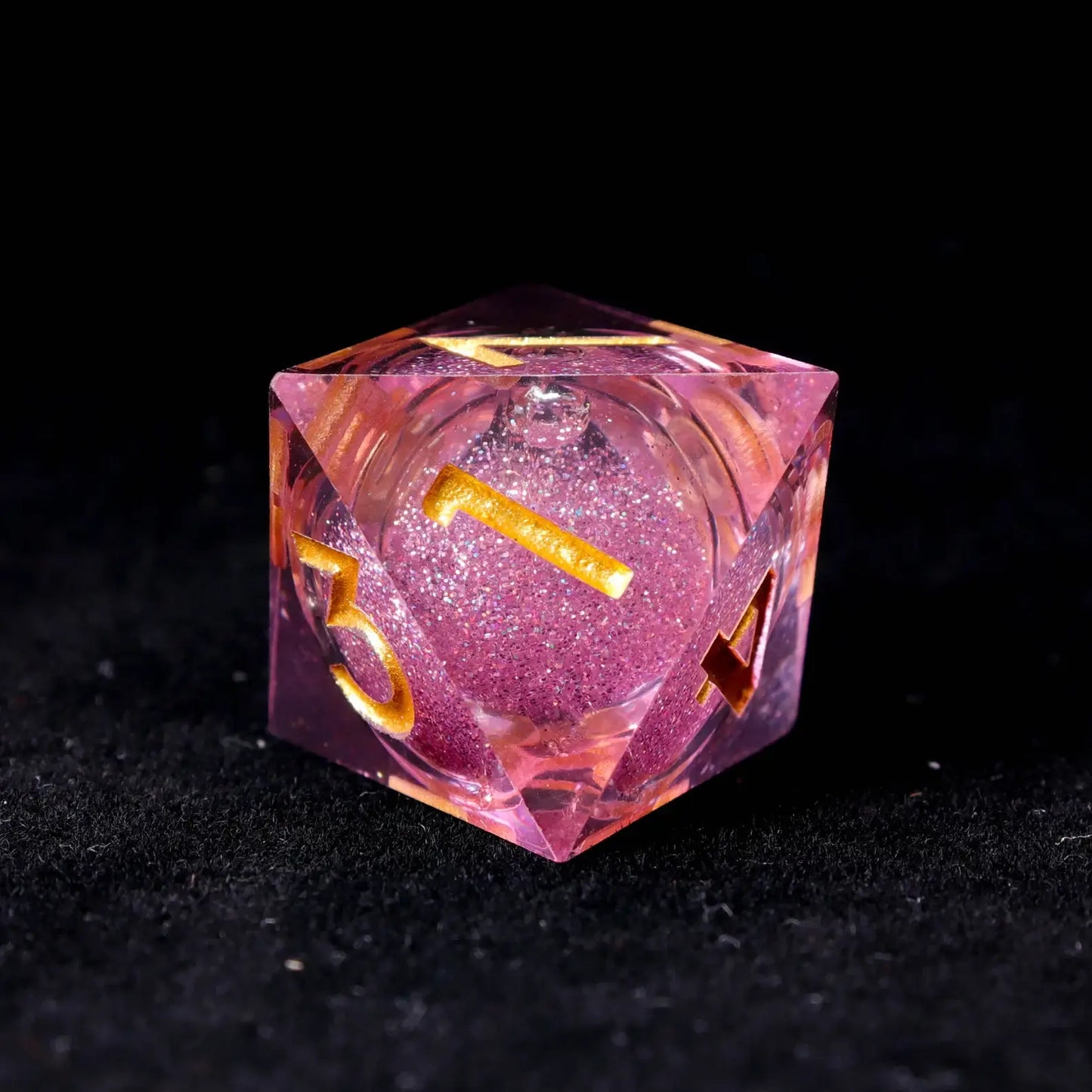 Top-down view showing the centered liquid core in a pink die, emphasizing randomness and fair balance for tabletop gaming.