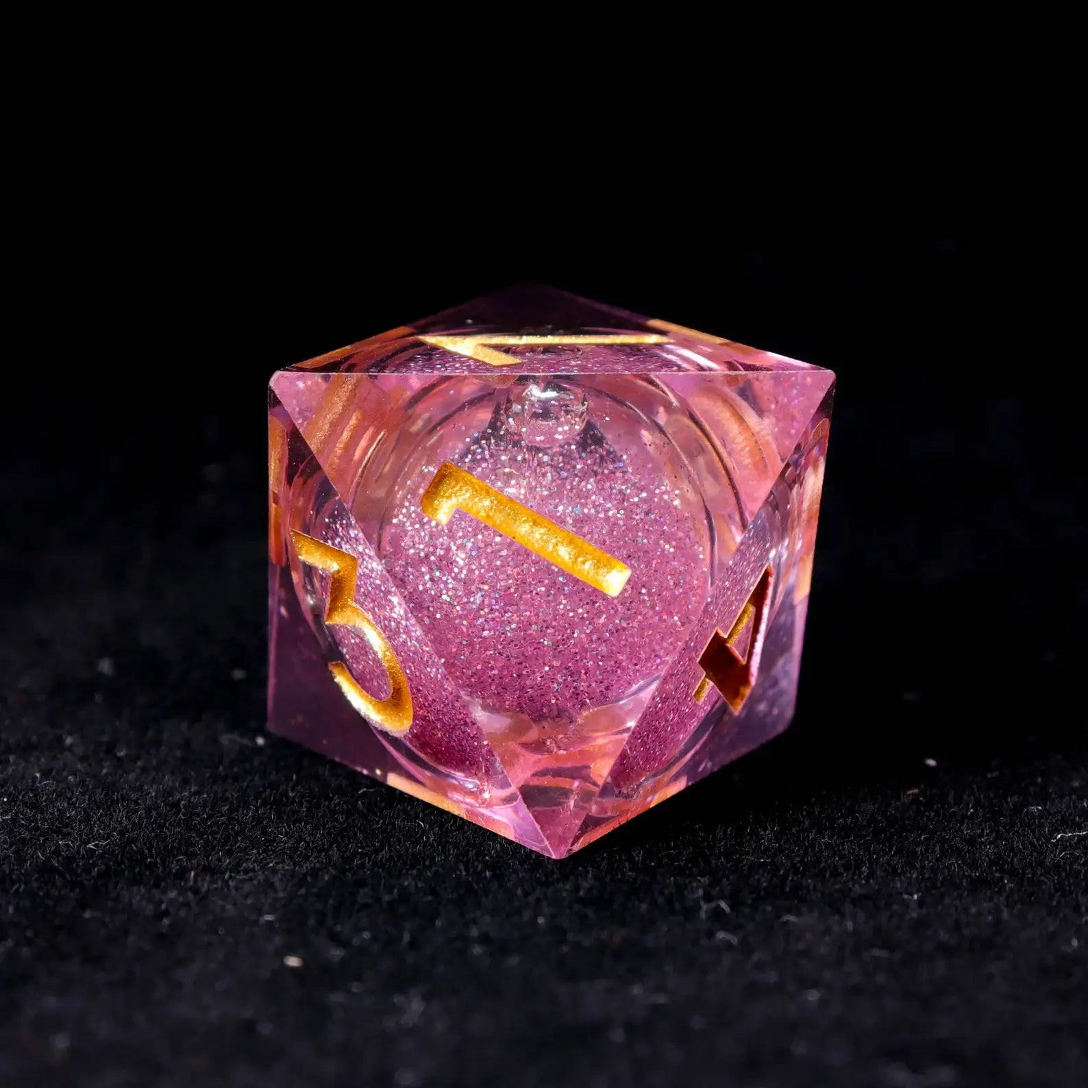 Top-down view showing the centered liquid core in a pink die, emphasizing randomness and fair balance for tabletop gaming.