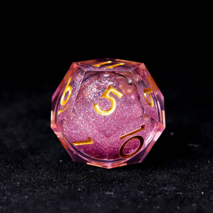 Multiple angles of pink liquid dice showing the dreamy interplay of pink and purple light refraction.