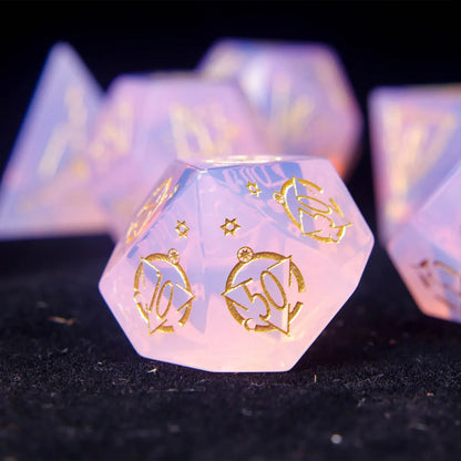 Pink opal D% percentile die with shimmering carved surface.