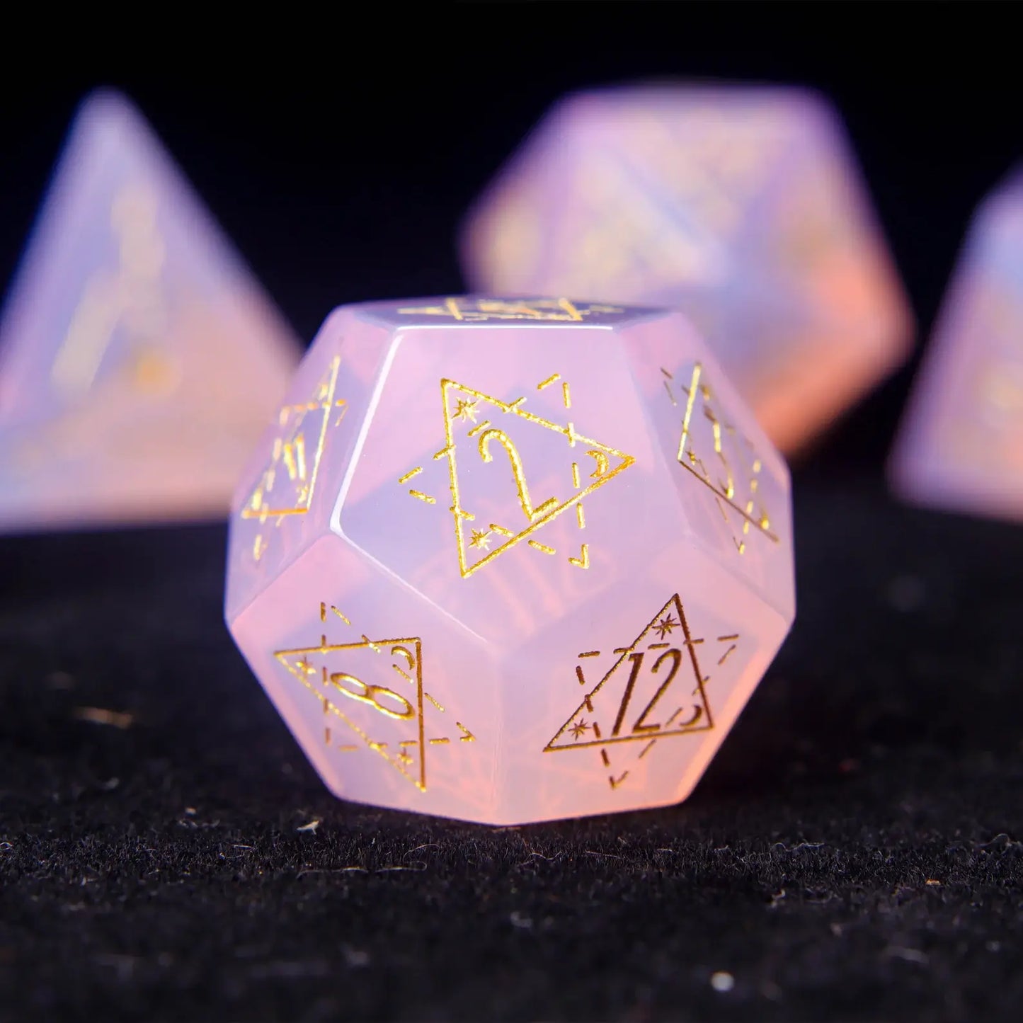 Pink opal D12 showcasing moon-like texture and hand-carved details.