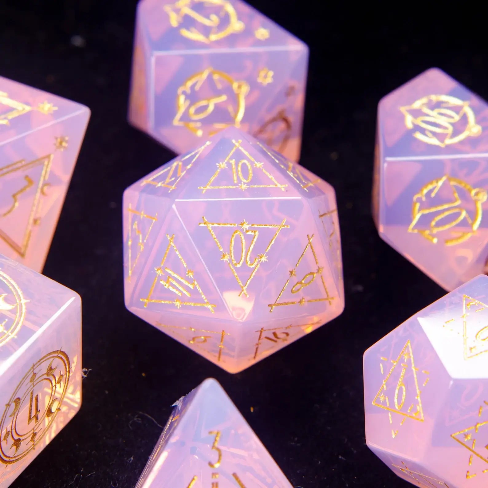 Pink carved opal D20 with galaxy-style engravings and glowing opal patterns.