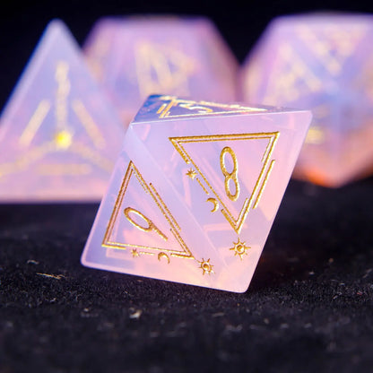 Pink carved opal D4 triangular die with soft glowing opal streaks.
