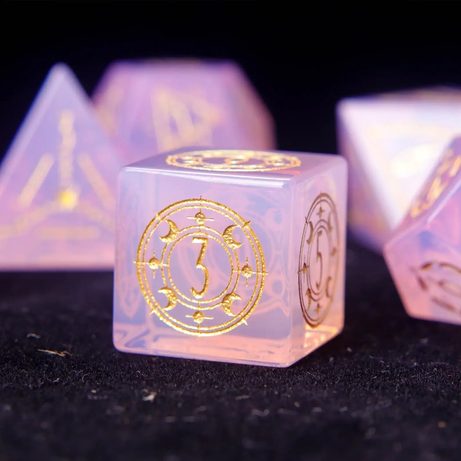 Pink opal D6 dice with luminous opal core and engraved symbols.