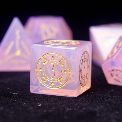 Pink opal D6 dice with luminous opal core and engraved symbols.