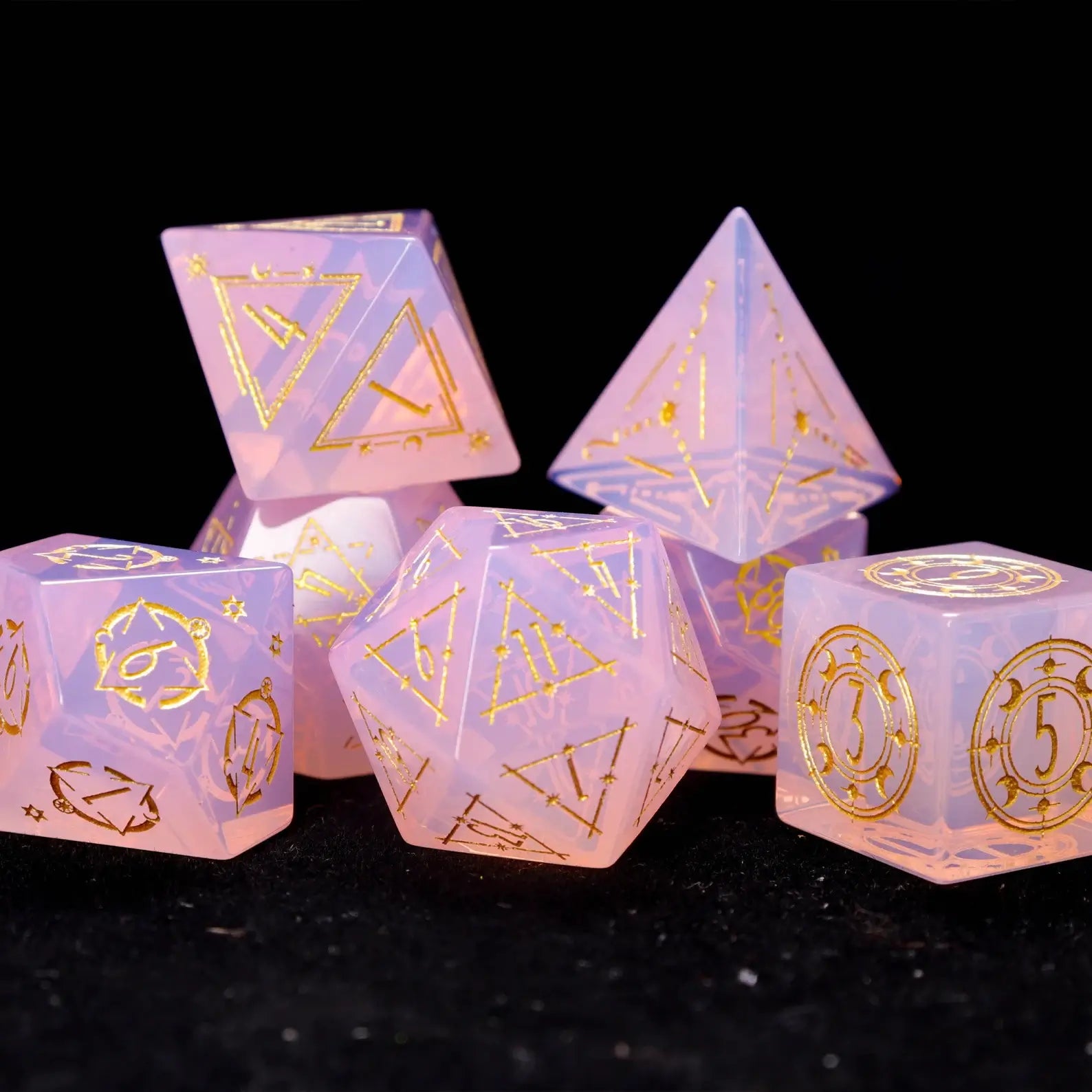 Close-up of the Pink Carved Opal Dice Set showing opal texture and carved patterns.