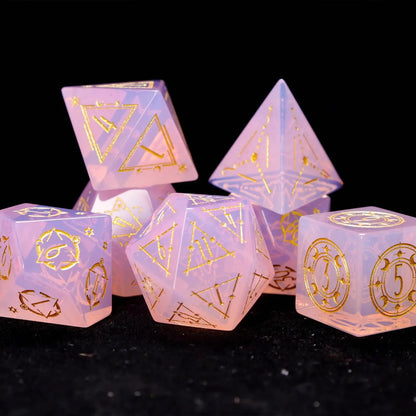 Close-up of the Pink Carved Opal Dice Set showing opal texture and carved patterns.