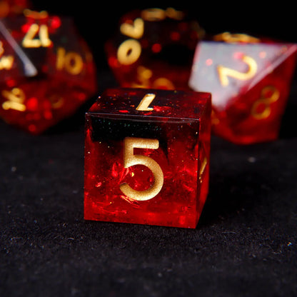 Close-up detail showing the precise, razor-sharp points and mirror-polished finish of a fiery red resin polyhedral die.