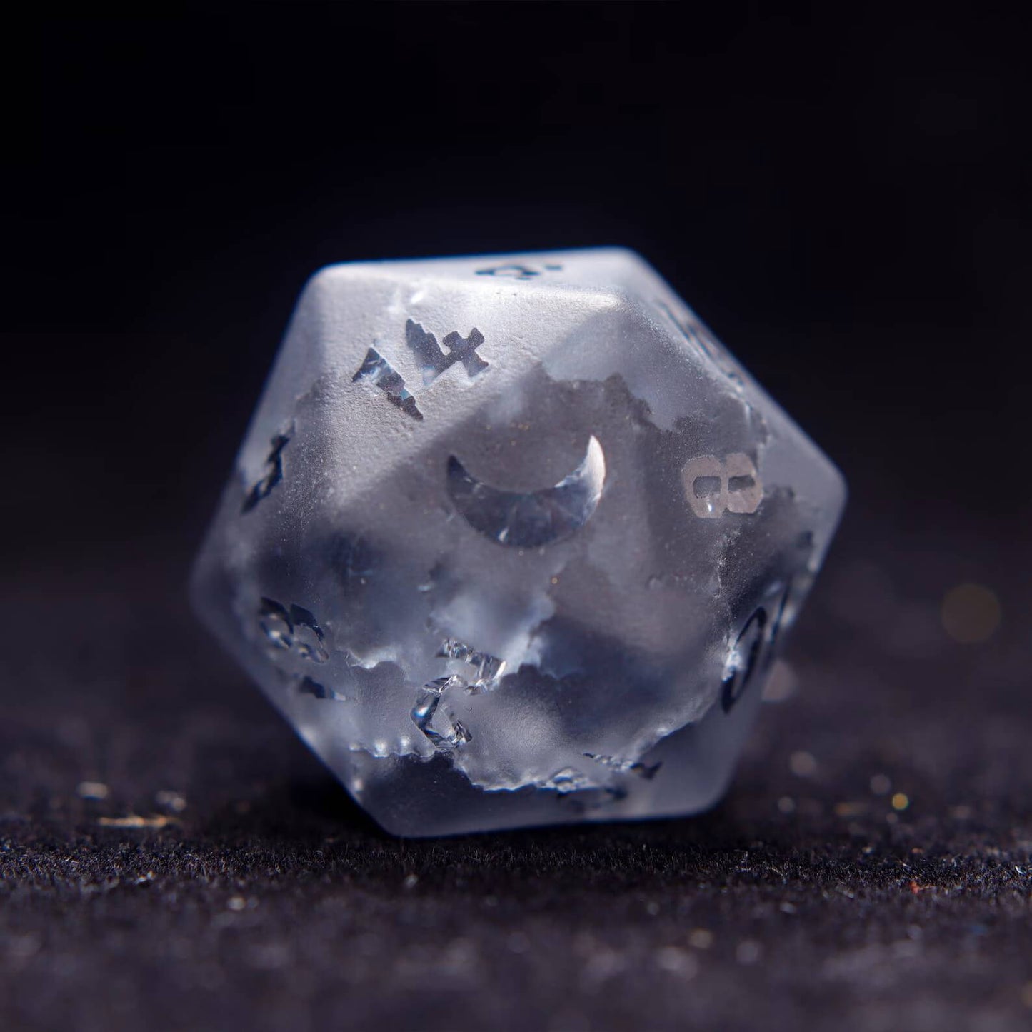 Close-up of the D20 from the best dnd dice set, showing intricate lightning-like veins in the grey gemstone on black.