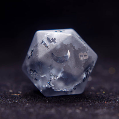 Close-up of the D20 from the best dnd dice set, showing intricate lightning-like veins in the grey gemstone on black.