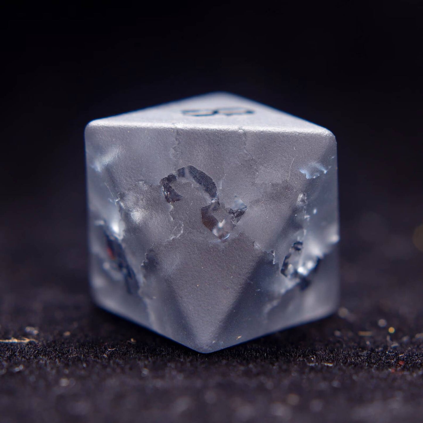 Detailed shot of the D8, showcasing the custom lightning-bolt numeral design on this unique gemstone dice.