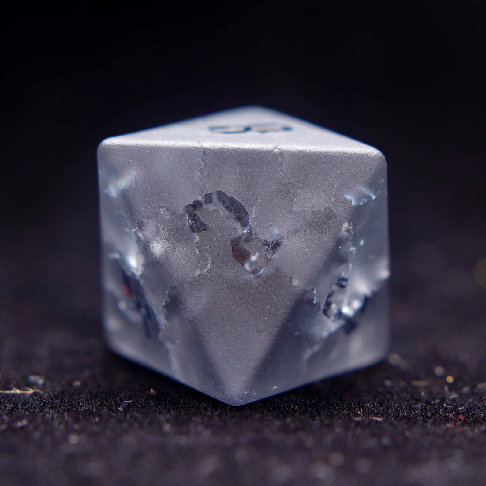 Detailed shot of the D8, showcasing the custom lightning-bolt numeral design on this unique gemstone dice.