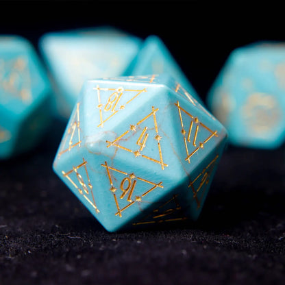 Extreme close-up of a single URDICE Green Howlite D20 die showing engraved numbers and stone texture.